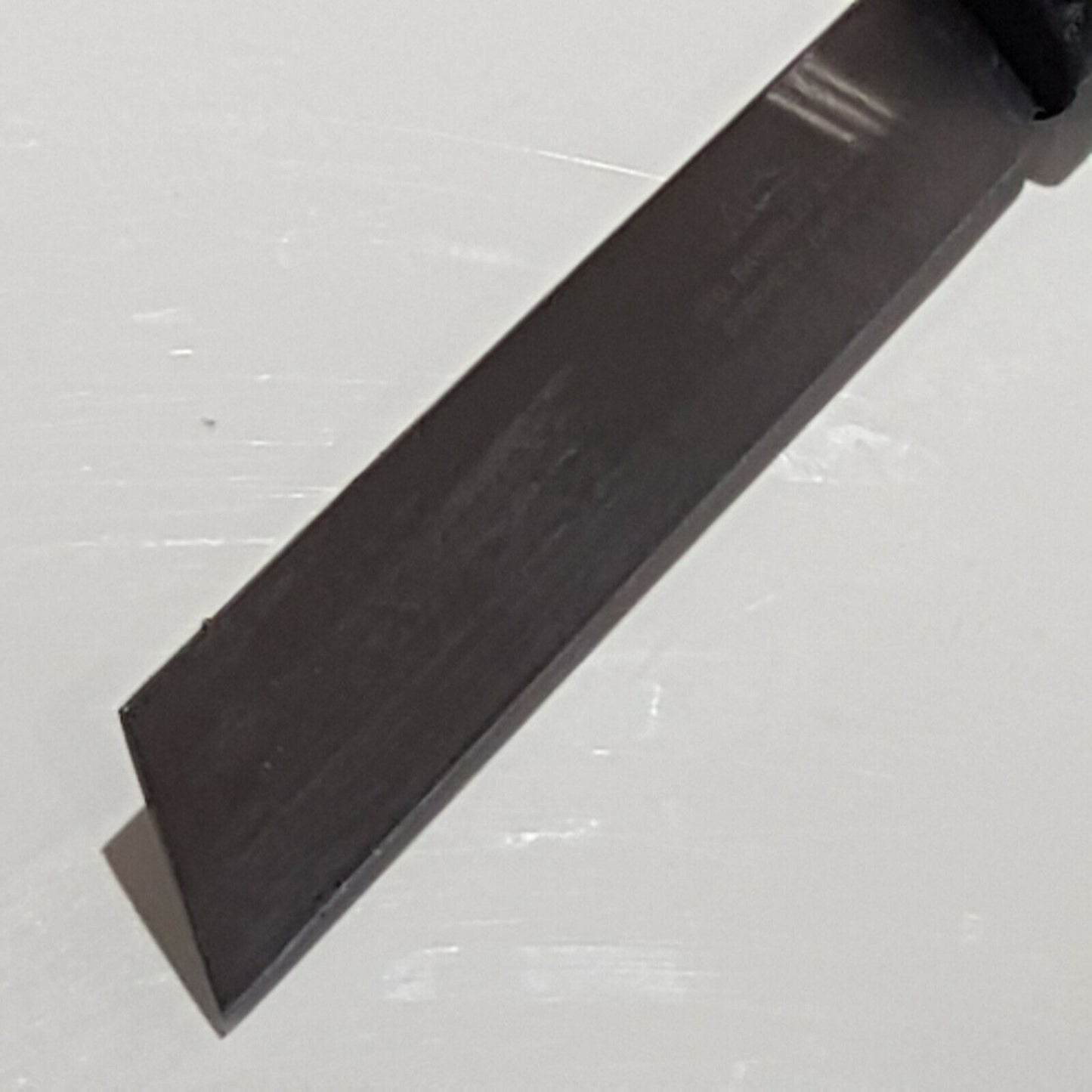 Close view of broad point heel parring knife of white background