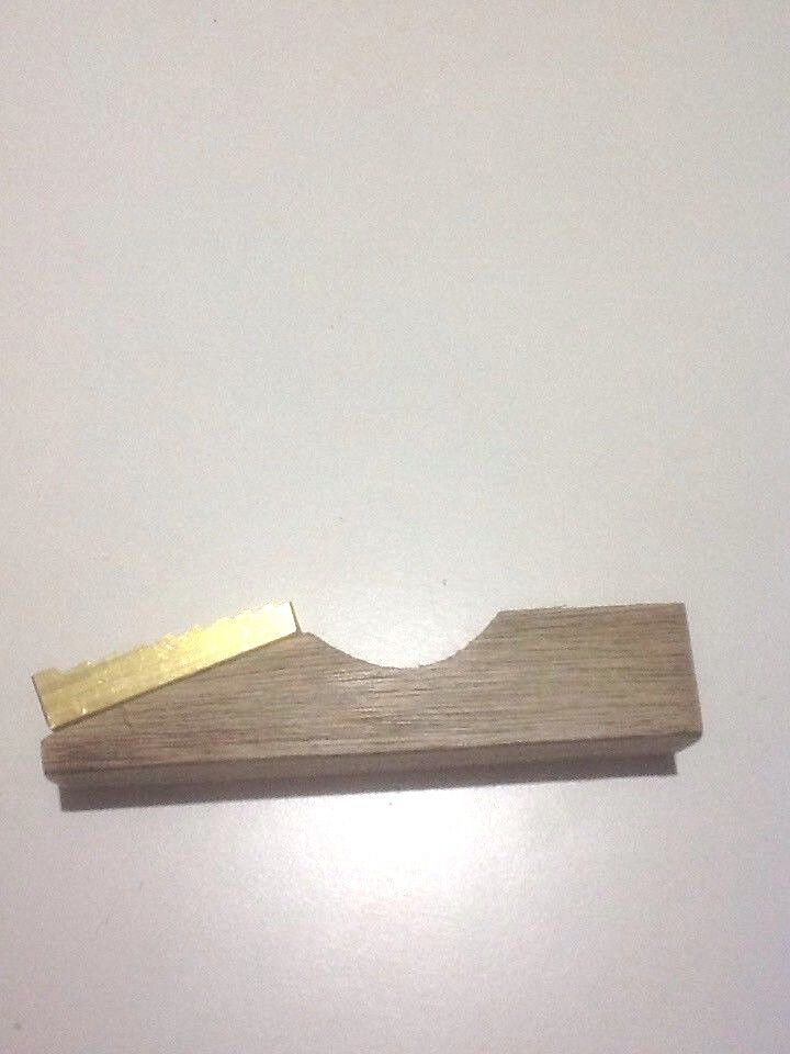 Wet Mill showing metal brass plate mounted on a base with white background