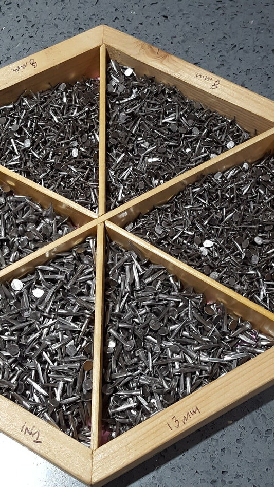 Wooden divided tray showing 8mm and 13mm sharp cut hand tacks