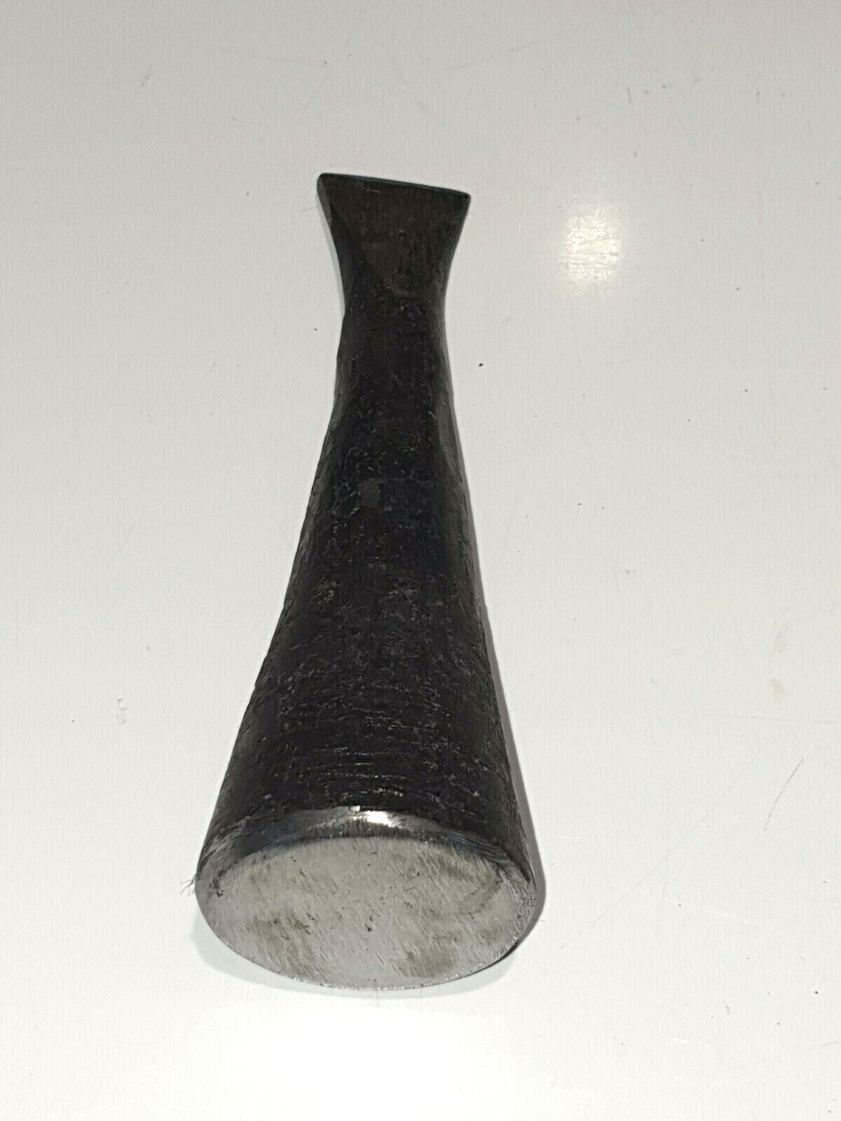 cast iron folding hammer shown lying down on white surface
