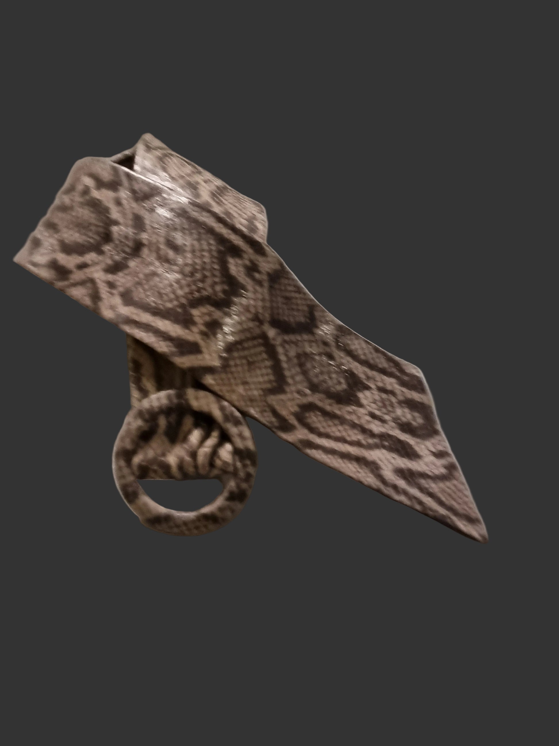 A snakeskin-patterned women with a matching leather covered buckle withot metal prong, displayed on a neutral gray background.
