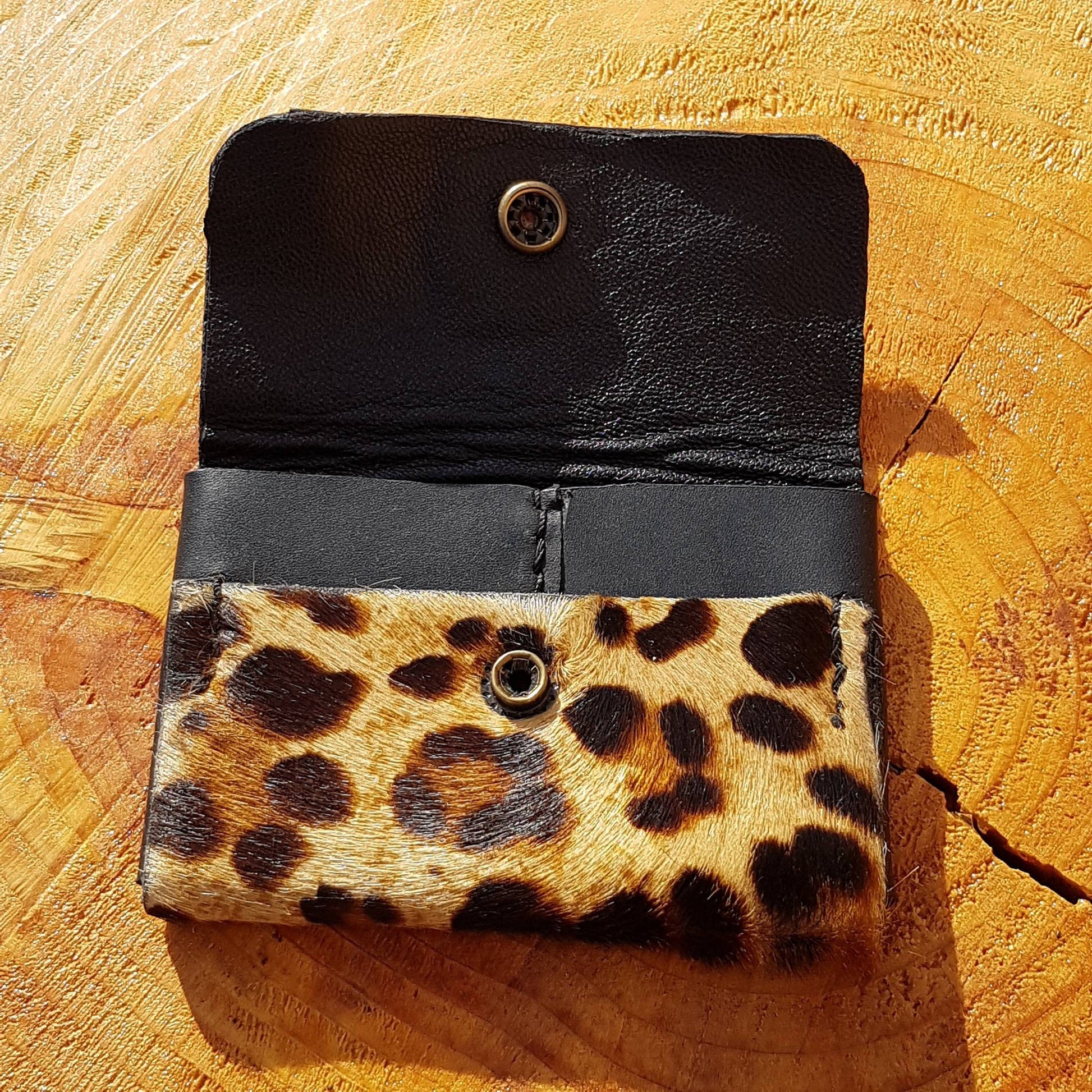 Close up view of opened leopard print hair-on leather wallet 