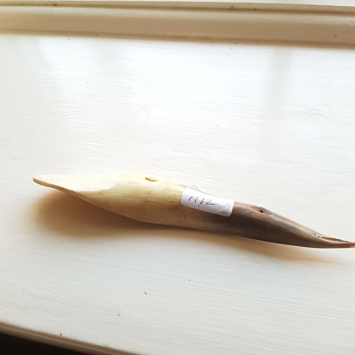A curved cow horn titles H12 used for leather finishing tasks such as opening sewn welts, burnishing, and polishing.