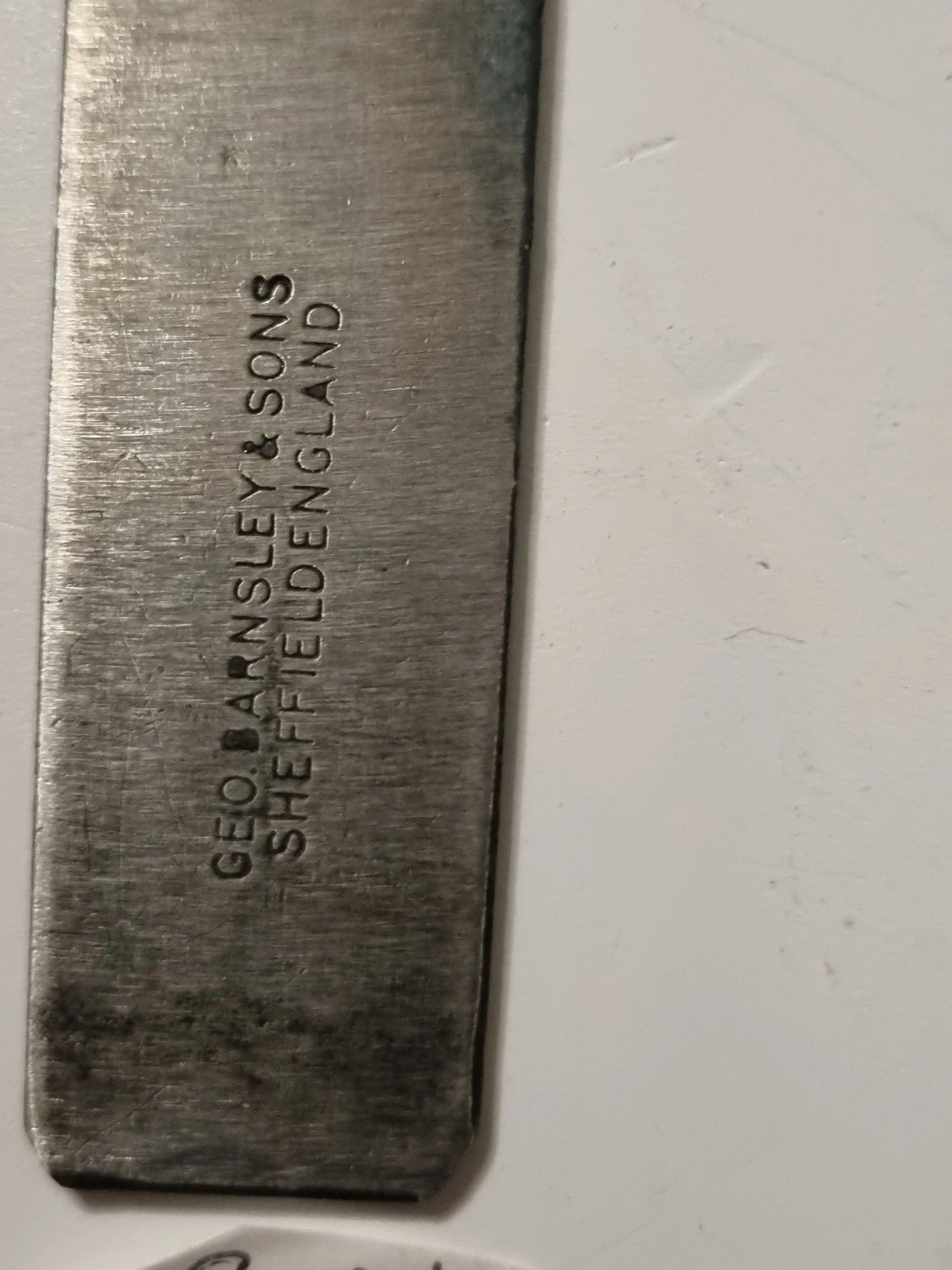 A close-up of a rectangular metal tool or bar engraved with the brand name 'GEO BANSLEY & SONS SHEFFIELD ENGLAND' on a white background.