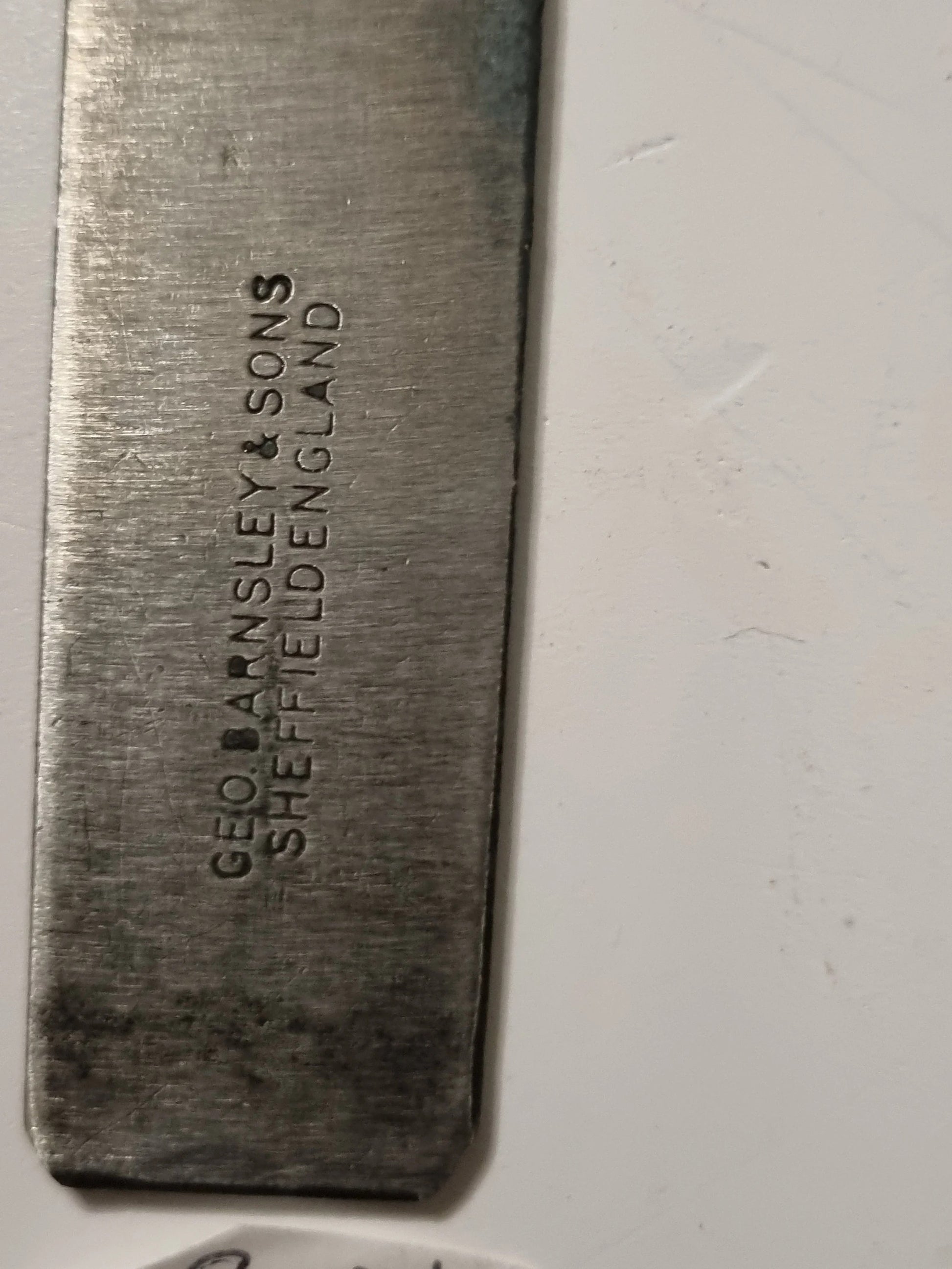 A close-up of a rectangular metal tool or bar engraved with the brand name 'GEO BANSLEY & SONS SHEFFIELD ENGLAND' on a white background.