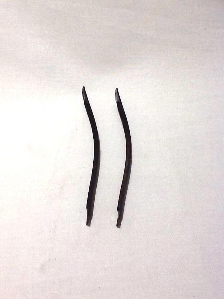 A pair of black steel shanks for ladies boots or shoes laid on a white surface.