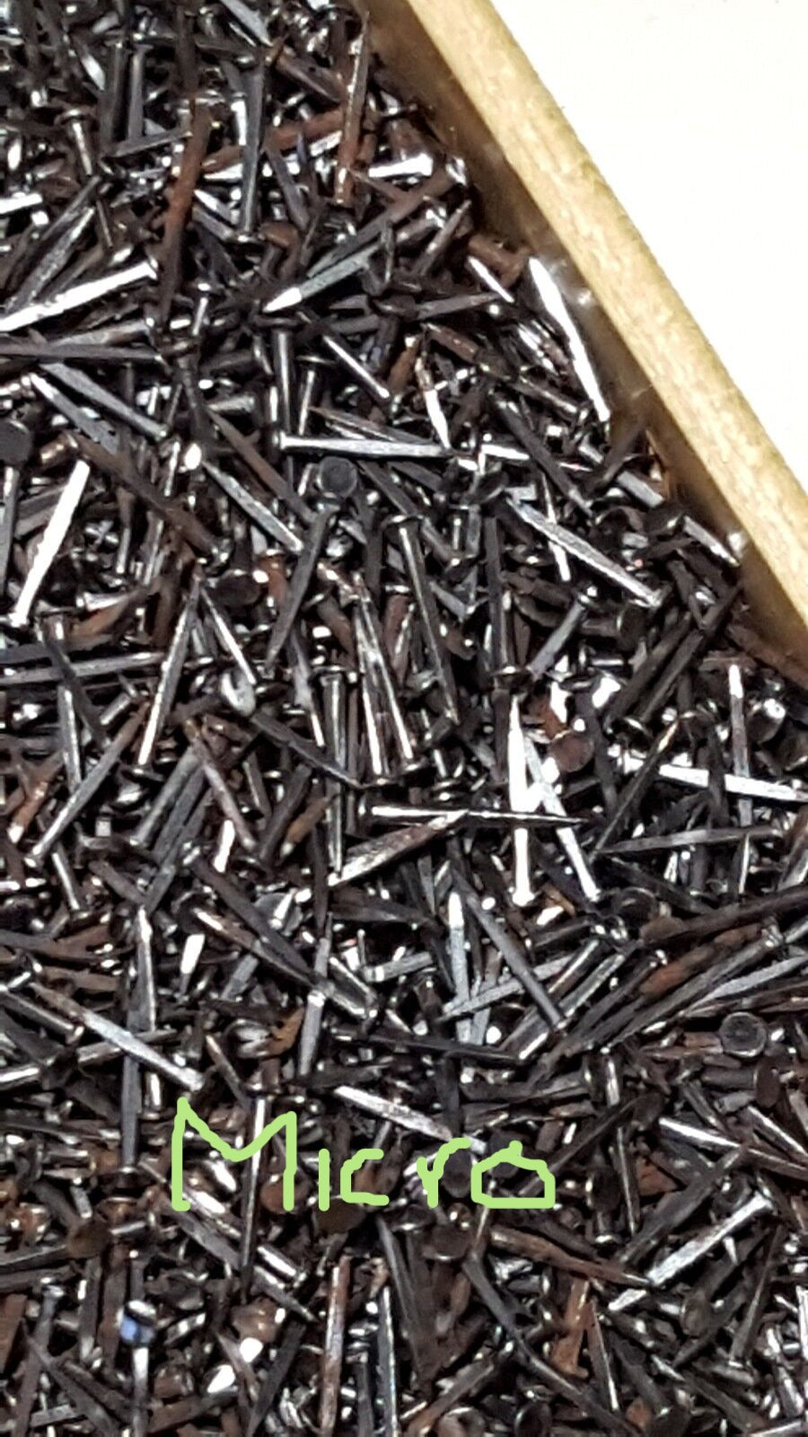 A box filled with micro tingles metal shoe nails used for tacking toe and back heel in shoe making.