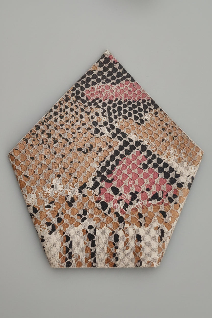 Leather suit square pocket made of leather in snakeskin style with mix colours of beige, brown, pink, and black, displayed on a solid blue background.