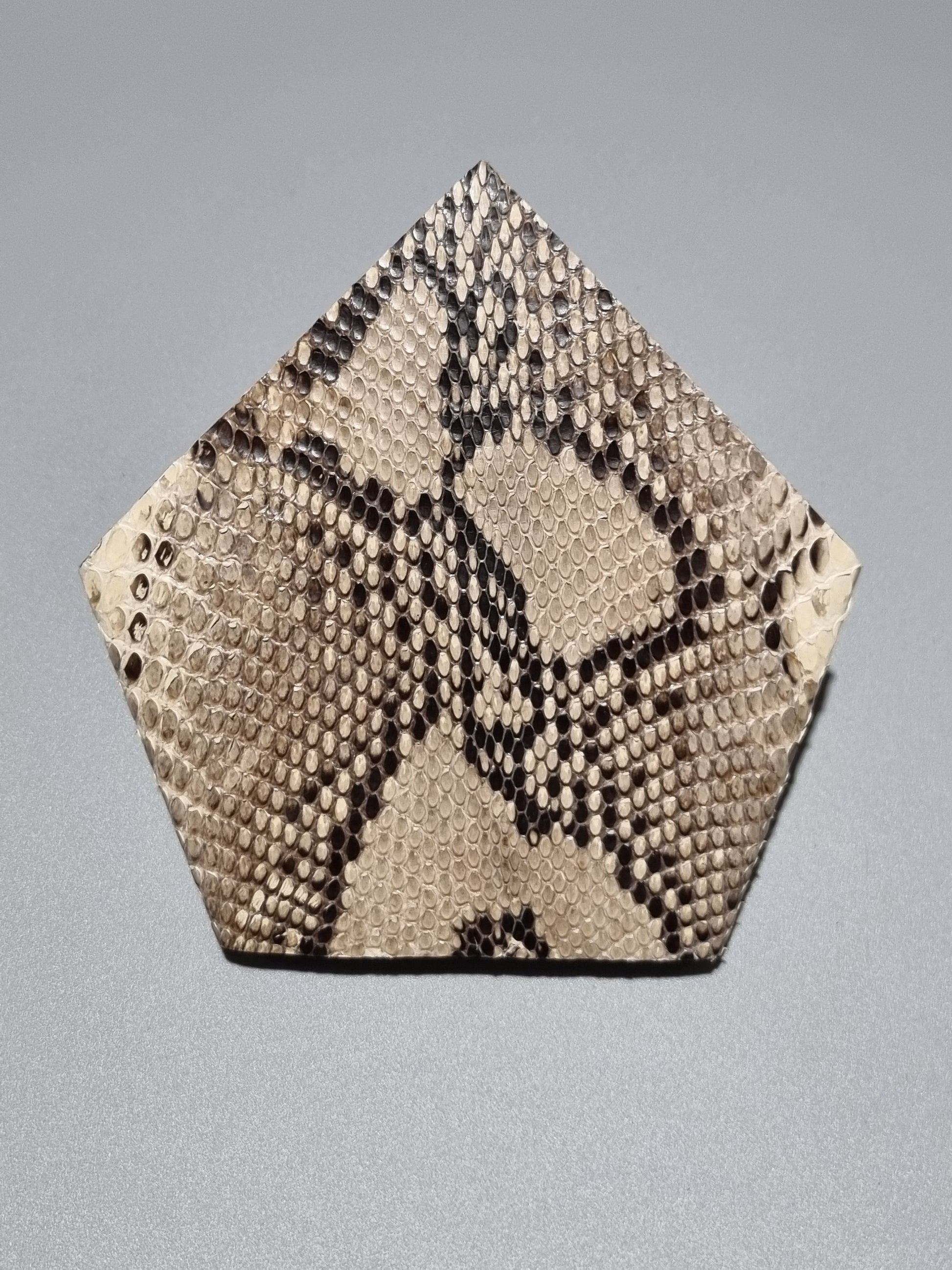 A square suit one point pocket made from natural python skin featuring a classic snakeskin pattern in beige, brown, and black, displayed on a neutral grey background.