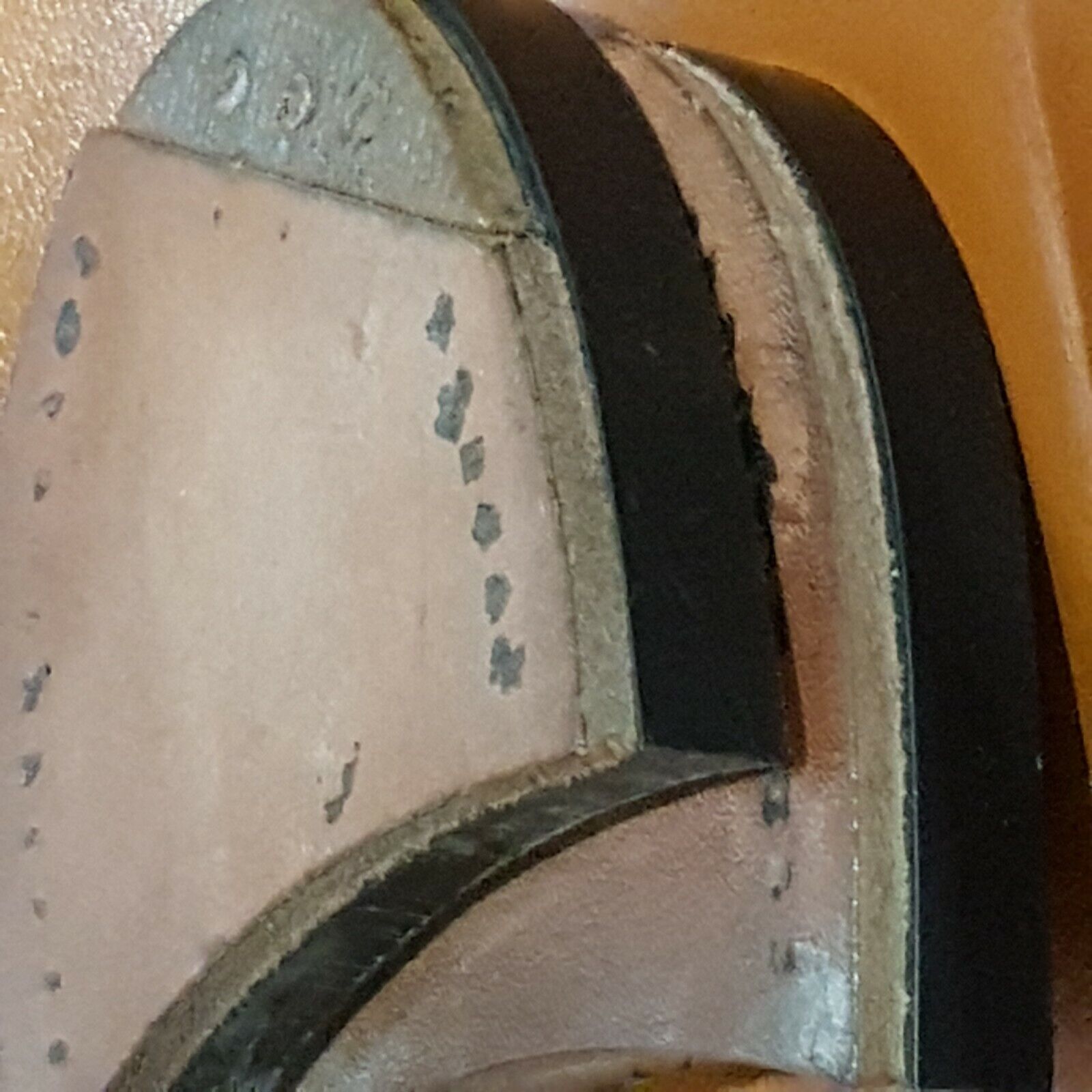 Close view quarter steel leather side view of heels mounted on PVC rubber block