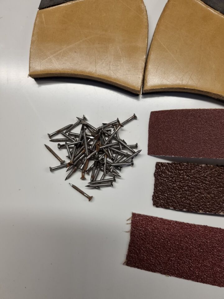 Close view of quarter Rubber Leather Heels Tacks Emery paper