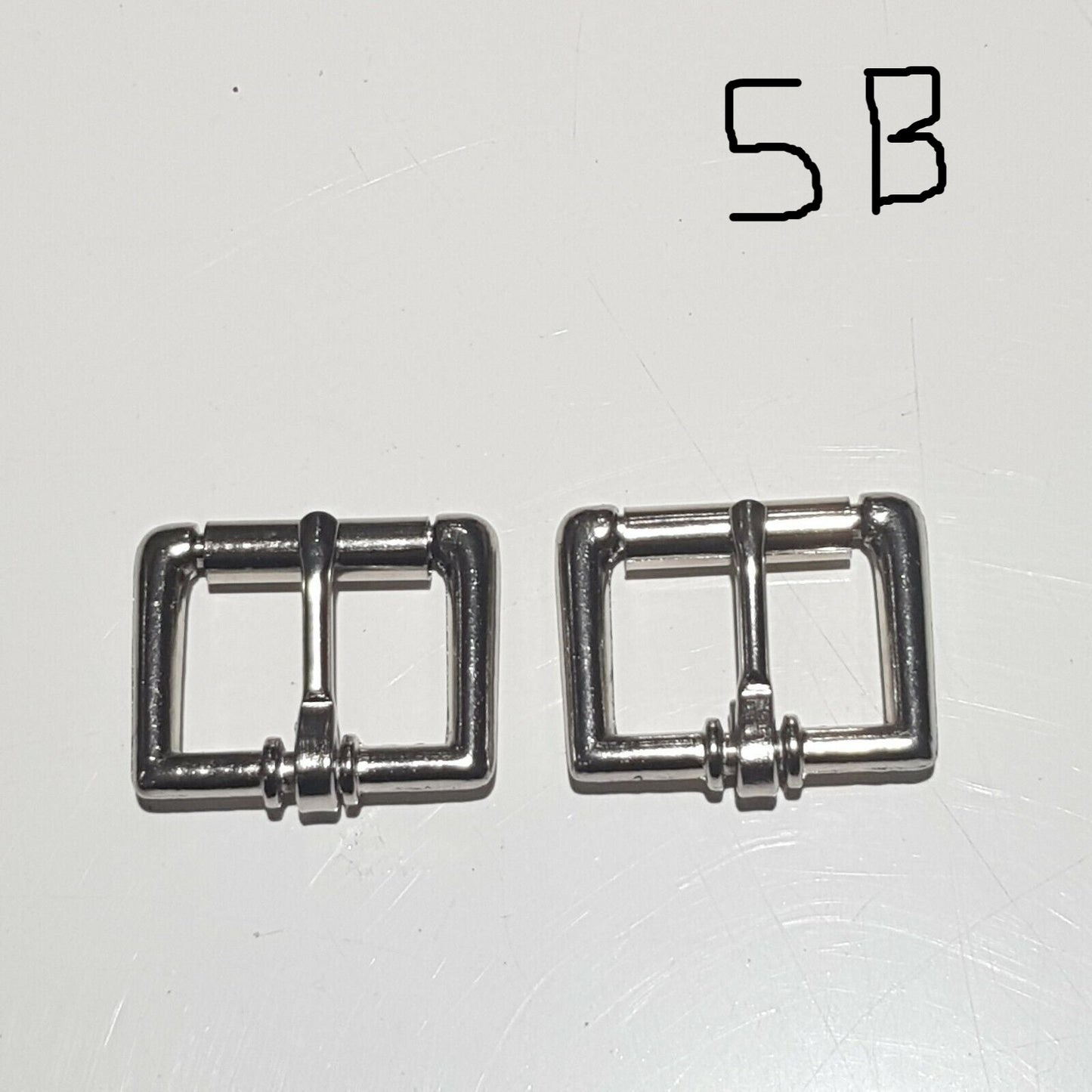Two metal buckles with a chrome finish on a white background, labelled 5B 