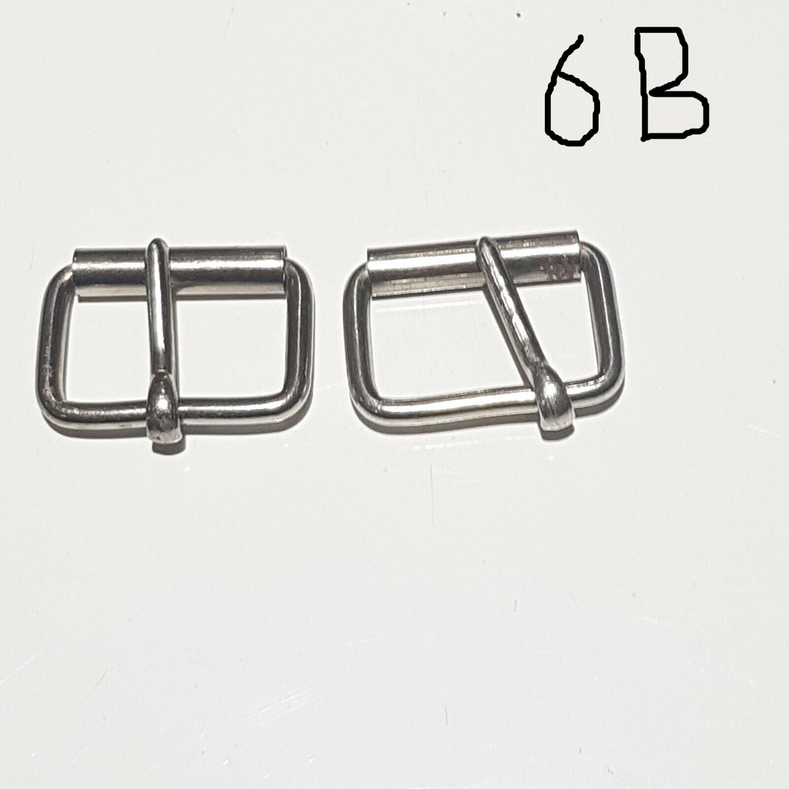 Two metal buckles with a chrome finish on a white background, labelled 6B 
