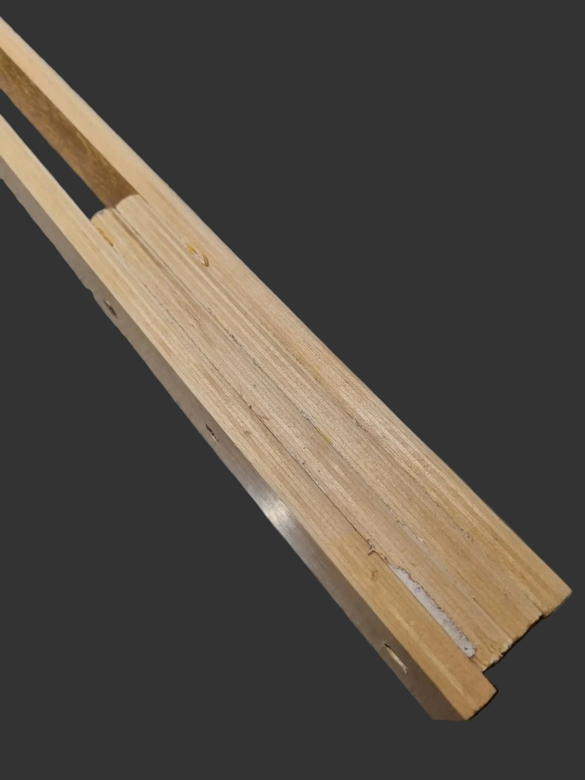 A close-up of a pair of wooden slats showing base construction made up of four slats