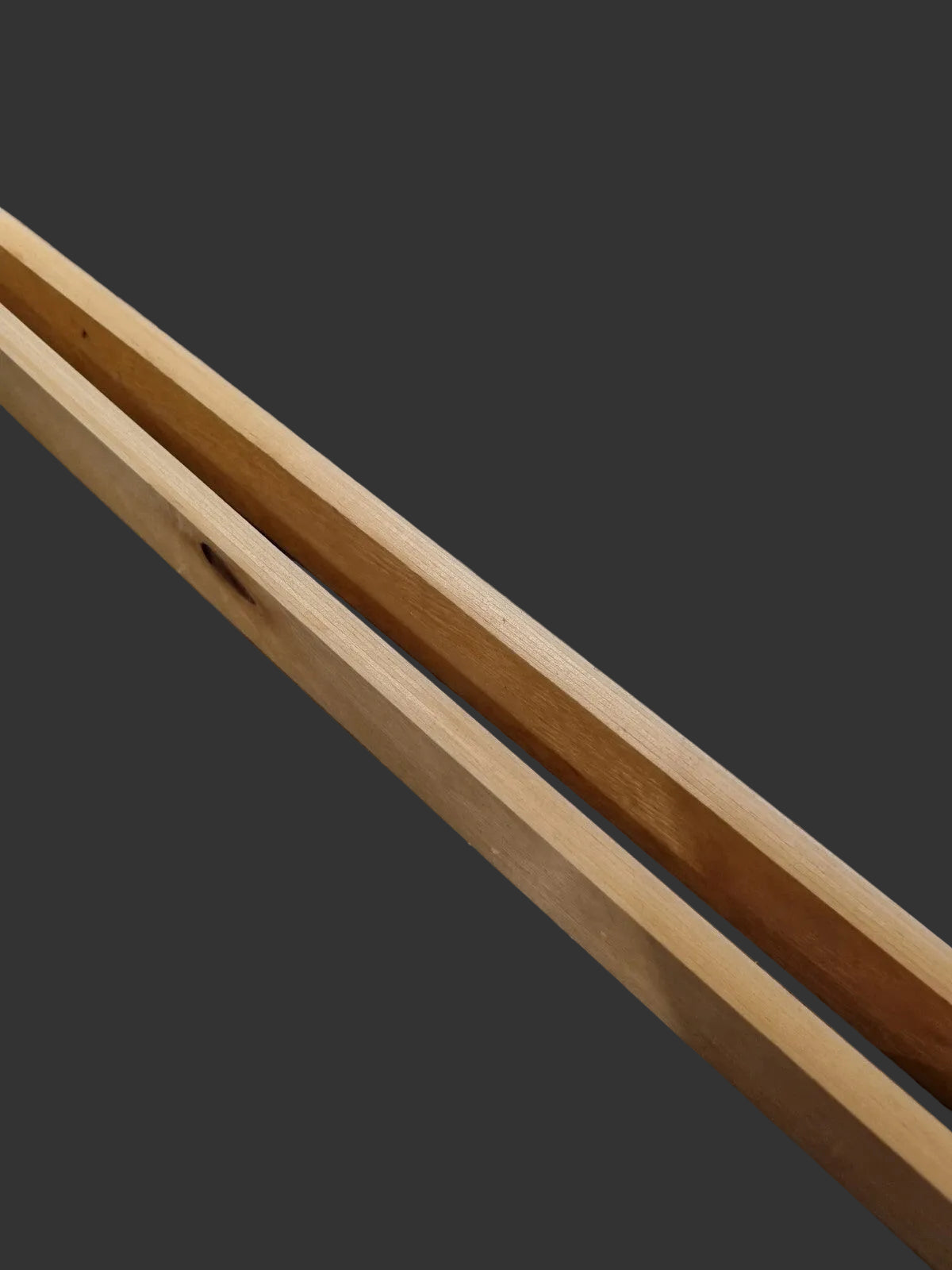 Two light natural birch wood slats placed diagonally 
