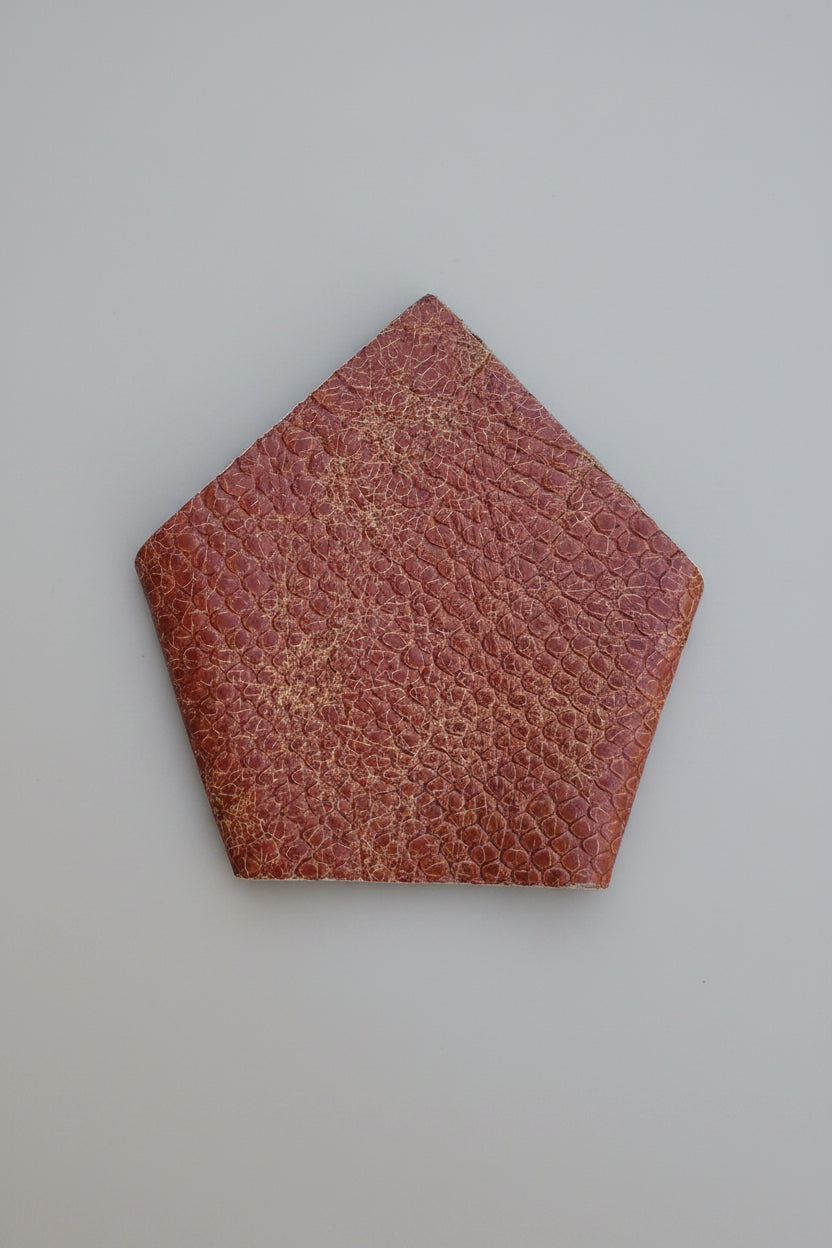 Tan colour leather suit square pocket  with a cobra snake pattern, displayed on a solid blue background.