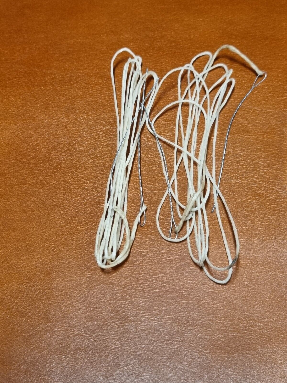 Handmade pair of wire bristle attached to waxed threads for hand stitching