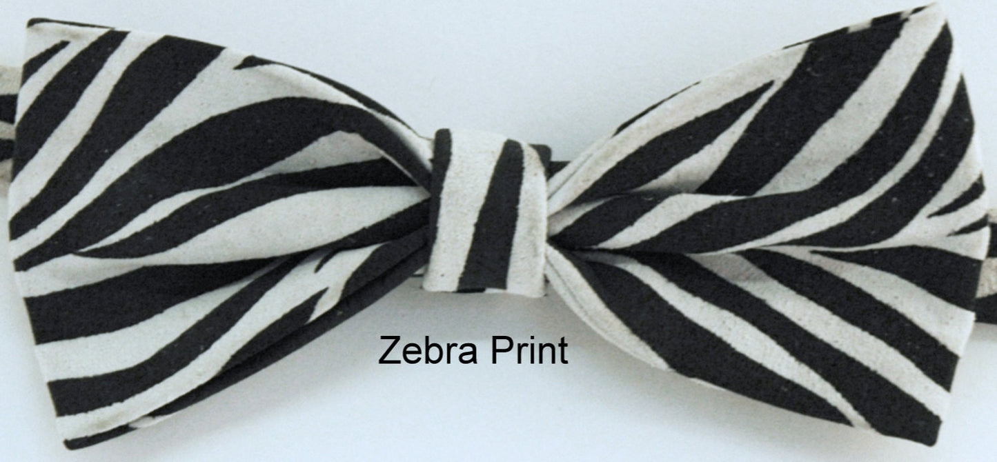 A zebra print leather bow tie with a black and white color scheme, displayed on a neutral background with the text 'Zebra Print' indicating the design origin.