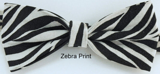 A zebra print leather bow tie with a black and white color scheme, displayed on a neutral background with the text 'Zebra Print' indicating the design origin.